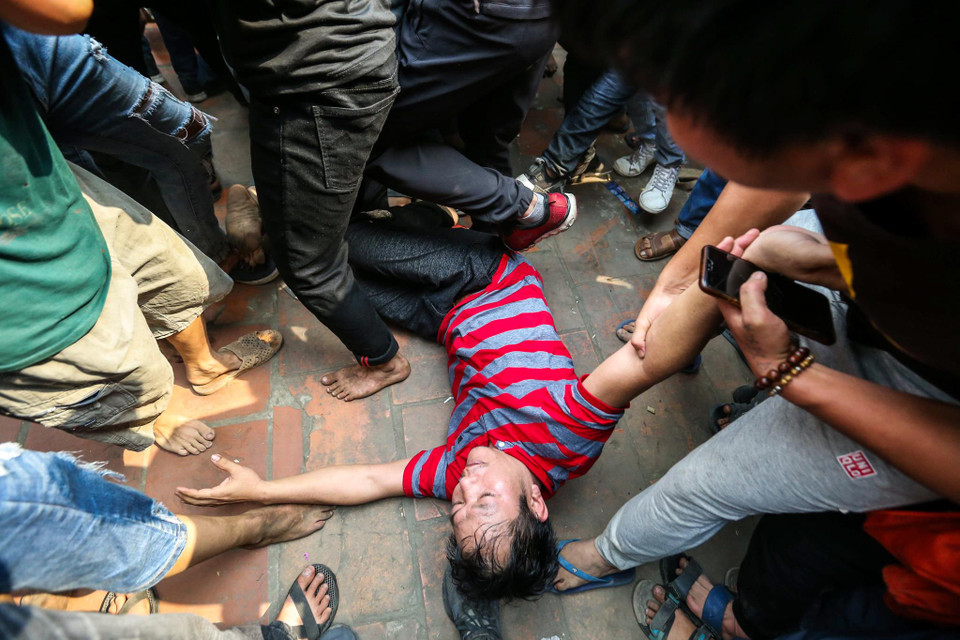 Thậm chí một số người đuối sức ngã quỵ xuống. (Ảnh: Minh Sơn/Vietnam+)