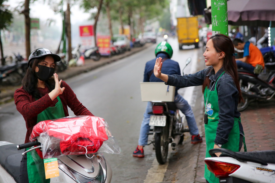 Mỗi ngày, 3 cô gái trẻ mở cửa hàng rất sớm giặt là cẩn thận từng bộ quần áo, từng đôi giày, rồi trực tiếp chuyển đồ cho những khách ở gần. (Ảnh: Minh Sơn/Vietnam+)