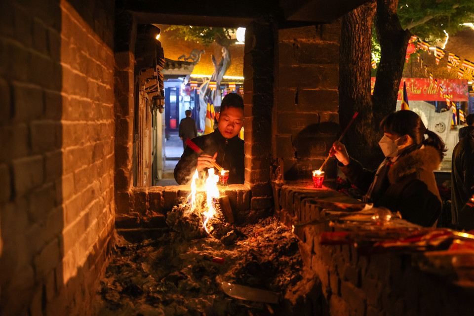 Người dân thắp thắp nhang cầu mong cho gia đình, người thân một năm mới nhiều sức khỏe, may mắn và bình an. (Ảnh: Minh Sơn/Vietnam+)