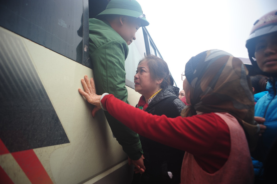 Dặn dò con cháu trước khi xe xuất phát. (Ảnh: Minh Sơn/Vietnam+)