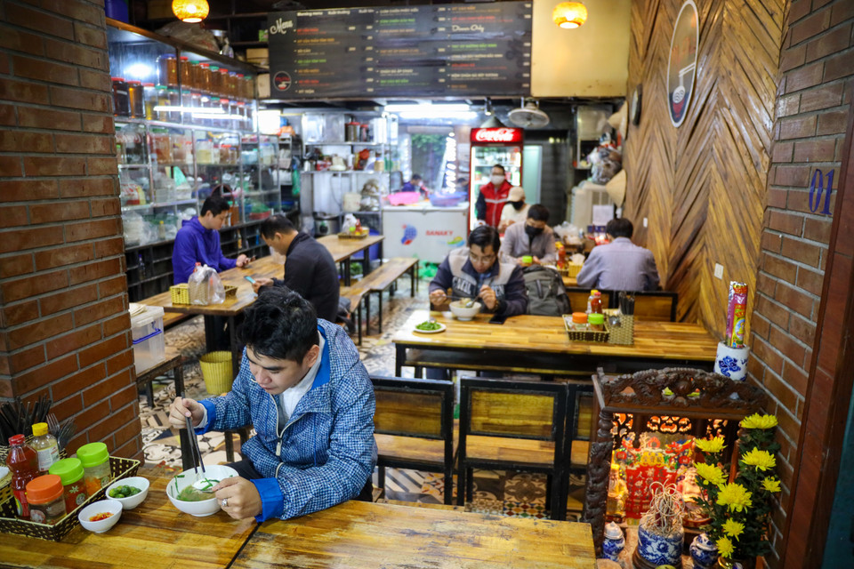 Các cửa hàng ăn uống, trung tâm thương mại… được hoạt động trở lại và các chủ cửa hàng ăn phải sắp xếp bàn để giữ khoảng cách, nên có tấm chắn bằng mica hoặc kính, nilon để người ngồi đối diện không có khả năng lây nhiễm cho nhau. (Ảnh: Minh Sơn/Vietnam+)