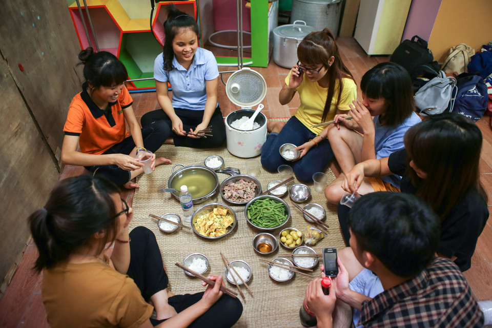 23 giờ đêm, các tình nguyện viên mới được ăn tối. Sau bữa cơm muộn màng, các bạn sẽ lại tiếp tục công tác chuẩn bị các suất ăn đến tận sáng hôm sau. (Ảnh: Minh Sơn/Vietnam+)