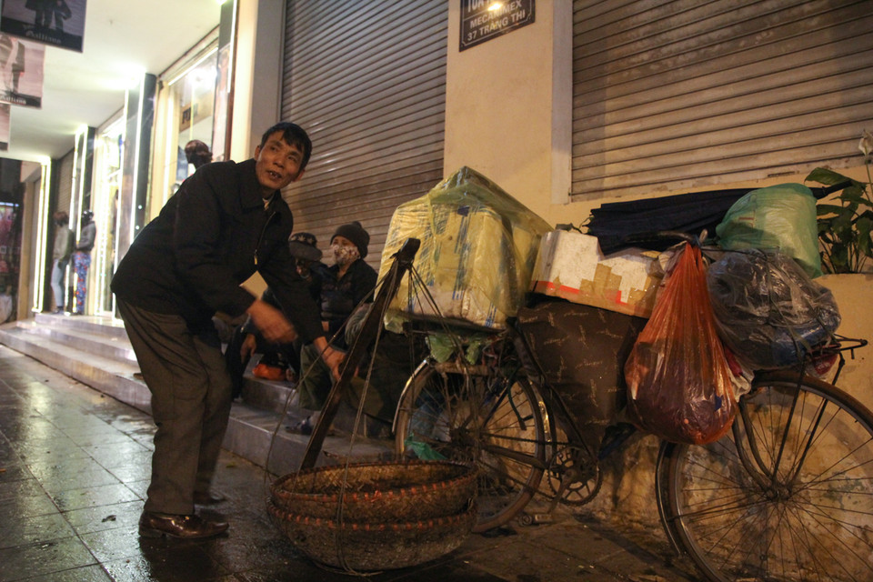 Với người lao động nghèo, ‘dãi nắng dầm mưa’ là chuyện thường ngày của họ. ‘Mưa mà nghỉ thì kiếm gì mà ăn bây giờ?’. Một người đàn ông ngậm ngùi chia sẻ. (Ảnh: Minh Sơn/Vietnam+)