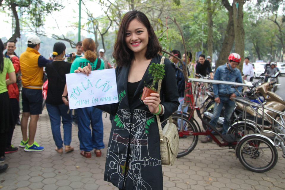 Biến thể từ trào lưu Free hugs (ôm tự do), người dân Hà Nội kêu gọi cùng nhau tham gia phong trào “Tree Hugs” (ôm cây) để ngăn chặn việc chặt bỏ cây xanh. (Ảnh: Minh Sơn/Vietnam+)