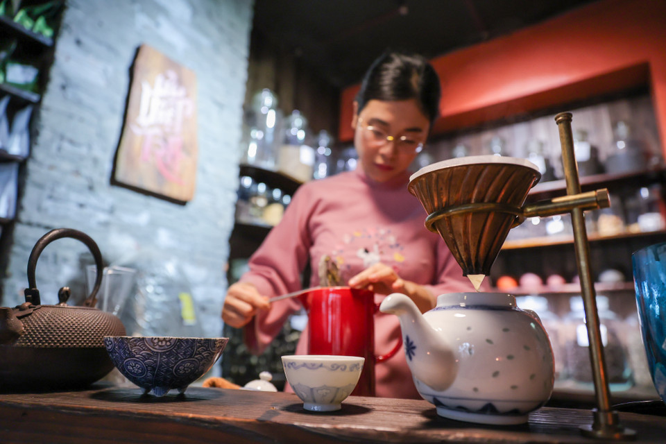 Trà nương 9X chia sẻ pha trà không đơn thuần chỉ để pha búp chè khô hòa lẫn nước rồi rót ra chén, mà ở đây pha trà là cả một nghệ thuật. Người được chọn làm trà nương cũng cần phải am hiểu trước hết về trà, về cách nhận biết, cách để trà ngấm, cách dâng trà. (Ảnh: Minh Sơn/Vietnam+)