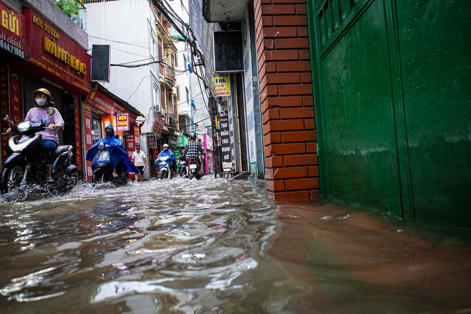 Do ảnh hưởng của hoàn lưu cơn bão số 2 gây mưa lớn kéo dài cả ngày không ngớt, nhiều tuyến phố ở Hà Nội ngập trong biển nước, thậm chí tình trạng này kéo dài cả đêm. (Ảnh: Minh Hiếu/Vietnam+)