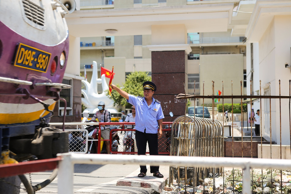 Nhân viên đường sắt tại nút giao Giải Phóng - Đại Cồ Việt mệt lả người sau mỗi chuyến tàu qua. (Ảnh: Minh Sơn/Vietnam+)