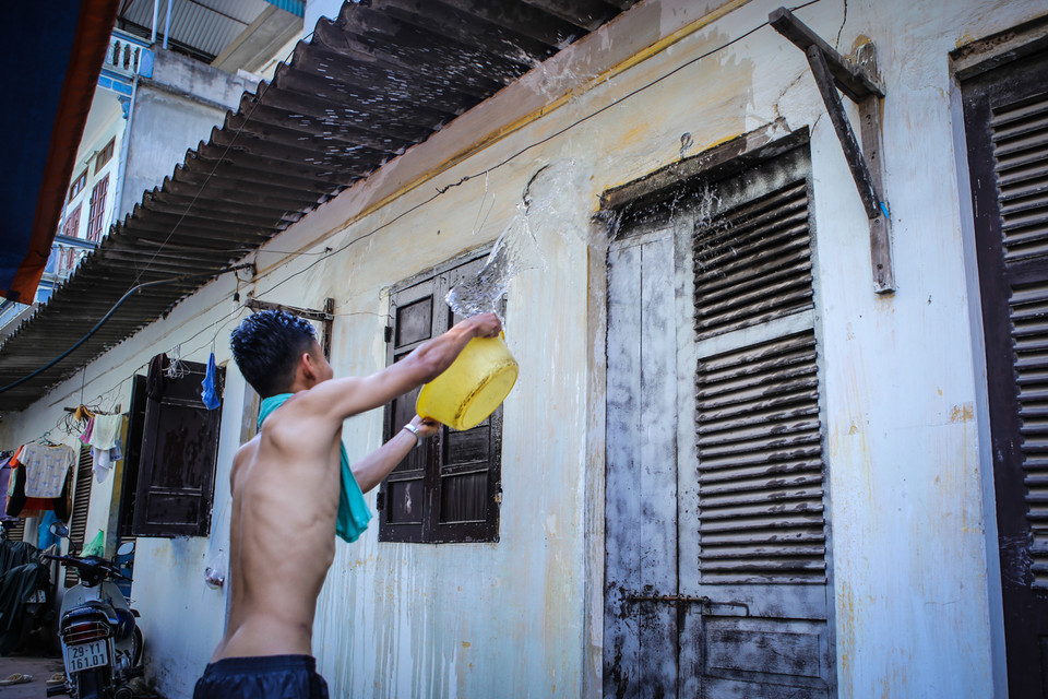 Thậm chí, các bạn còn đóng chặt cửa rồi dội nước lên khắp tường nhà để thoát nhiệt. (Ảnh: Minh Sơn/Vietnam+)
