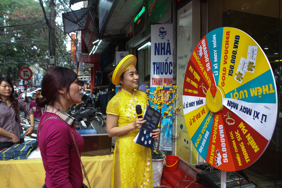 Để thu hút khách, một số cửa hàng bày ra trò quay trúng thưởng với nhiều phần quà giá trị. (Ảnh: Minh Sơn/Vietnam+)