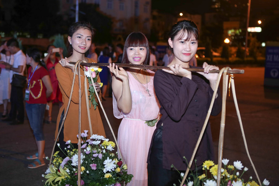 Trong chương trình này, các bạn trẻ sẽ được thử sức mình khi hóa thân vào các cô gái điệu đàng với gánh hàng hoa trên phố. (Ảnh: PV/Vietnam+)