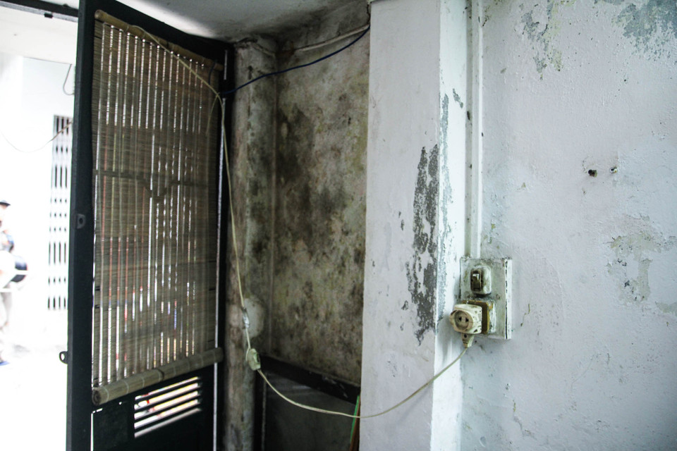 Chị Loan sống ở tầng trệt khu C5 chia sẻ: ‘Mỗi khi trời mưa lớn chị và gia đình phải chịu cảnh nước ngập vào nhà. Tường nhà sơn lại liên tục nhưng mỗi khi mưa lại ngấm vào khiến tường mốc meo, bẩn thỉu. (Ảnh: Minh Sơn/Vietnam+)