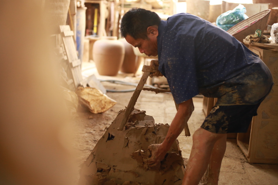 Gốm Hương Canh được làm từ đất sét xanh, khai thác tại địa phương, có độ mịn, độ béo cao, ít cát, ít xương hơn so với các loại đất nguyên liệu khác. Sau quá trình làm đất kỹ lưỡng, đất trở nên dẻo cho nên dễ vuốt mỏng và đặc biệt người nghệ nhân mặc sức tạo hình tạo nét cho sản phẩm. (Ảnh: PV/Vietnam+)