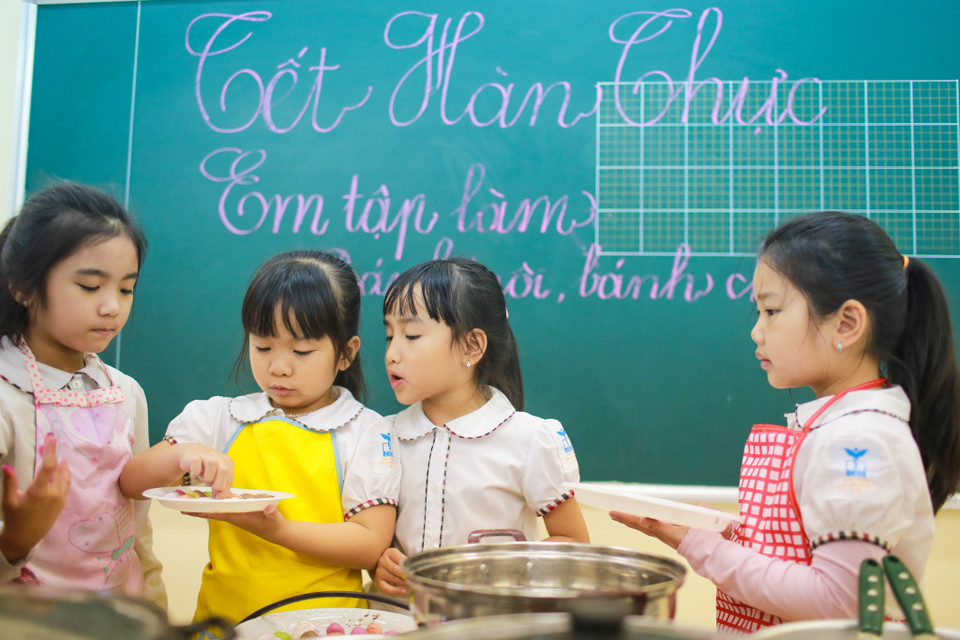 Chiều 8/4, các bé học sinh lớp Một được tham dự lớp học đặc biệt về cách làm bánh trôi, bánh chay ngũ sắc khi ngày Tết Hàn thực đang đến gần. (Ảnh: Minh Sơn/Vietnam+)