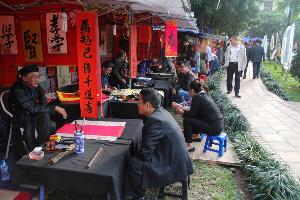 Bác Nguyễn Thế Sùng, một ông đồ đang ở tại hồ Văn cho biết, cả ngày mới cho được hơn chục chữ. Chủ yếu người ta đến hỏi là chính. (Ảnh: Minh Sơn/Vietnam+)