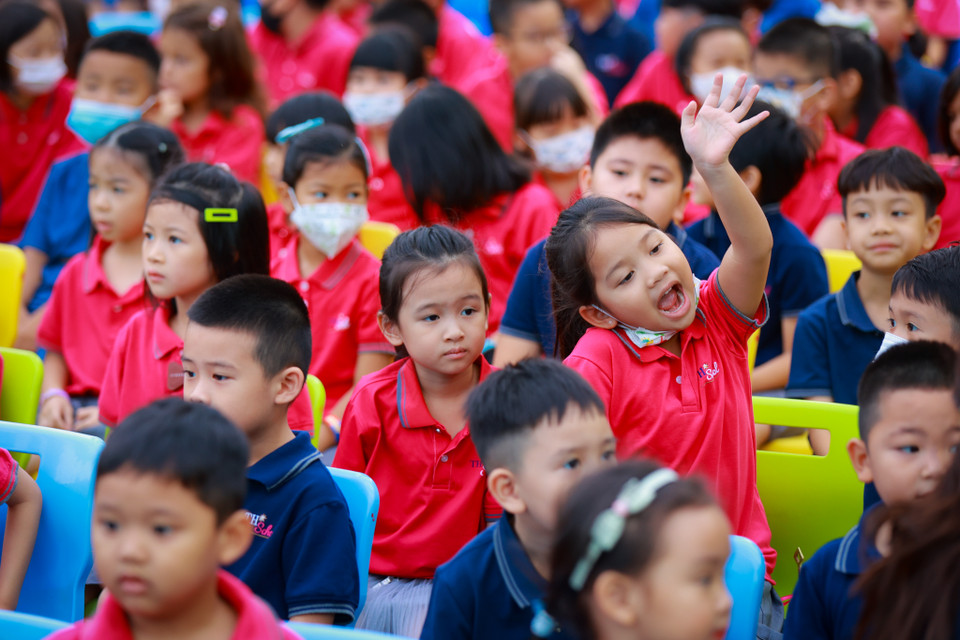 Các bạn học sinh vẫy tay chào các bé mẫu giáo lần đầu tiên được tham dự lễ khai giảng. (Ảnh: Minh Sơn/Vietnam+)