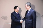 Thủ tướng Phạm Minh Chính gặp Phó Thủ tướng Trung Quốc Đinh Tiết Tường. (Ảnh: Dương Giang/TTXVN)