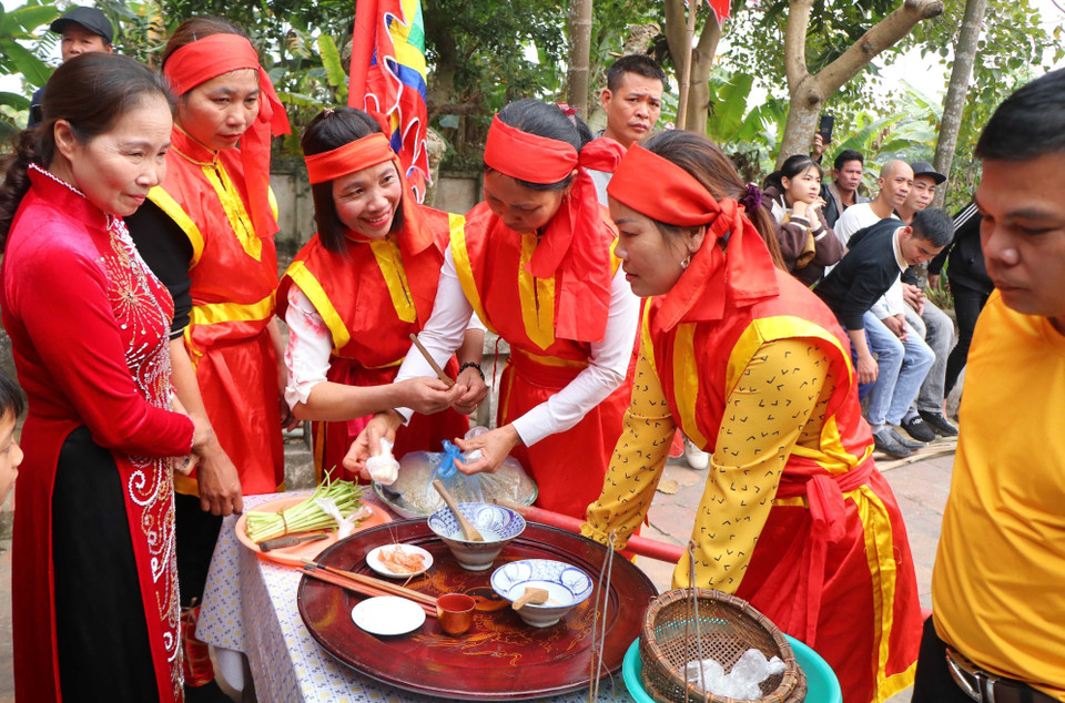 Phụ nữ của các đội thi chuẩn bị đồ dùng và nguyên liệu để chuẩn bị cho hội thi kéo lửa, thổi cơm. (Ảnh: Trung Kiên/TTXVN)