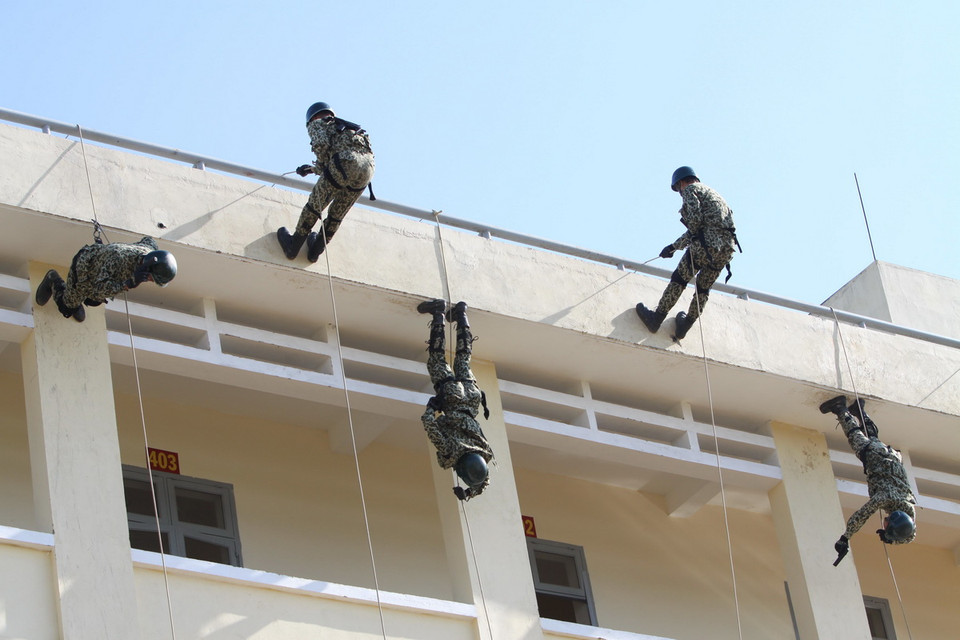  Các lực lượng đặc công tiến công giải thoát con tin theo tình huống giả định.(Ảnh: An Hiếu/TTXVN)