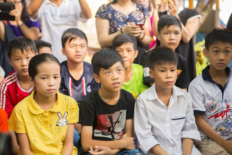 Các em nhỏ rất tập trung khi lắng nghe những lời chia sẻ của đại sứ Mỹ Ted Osius. (Ảnh: Tiến Đạt/Vietnam+)