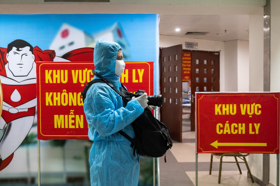 Phóng viên Minh Quyết, Ban Biên tập ảnh Thông tấn xã Việt Nam tác nghiệp trong khu cách ly phòng COVID-19 của Viện Huyết học Truyền máu Trung ương. (Ảnh: TTXVN)