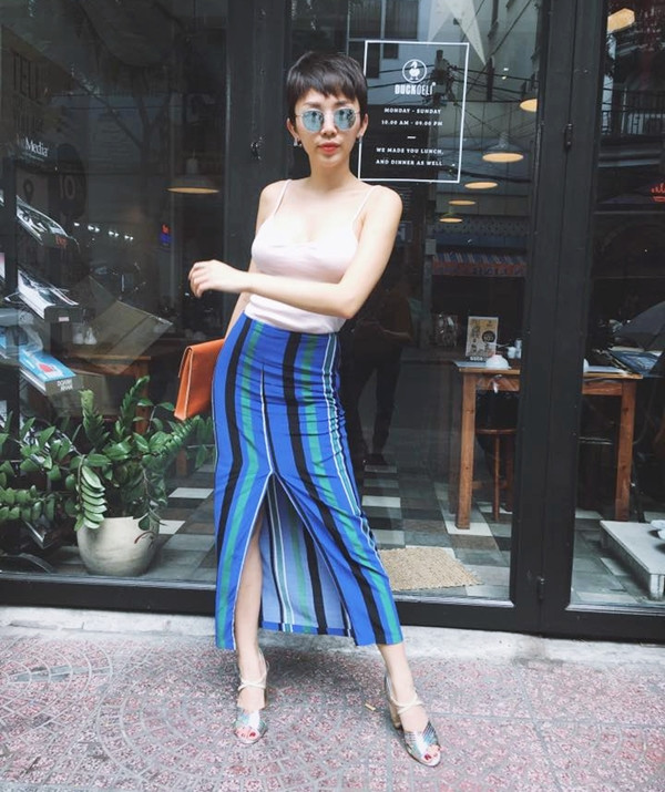 Khai thác triệt để đường cong gợi cảm, Tóc Tiên kết hợp áo 2 dây với chân váy kẻ xanh có chi tiết xẻ cao quyến rũ
