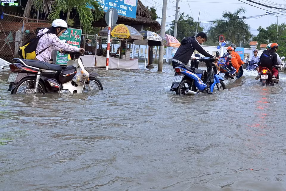 Người dân lưu thông khó khăn trên đường Lê Văn Lương (huyện Nhà Bè). (Ảnh: Mạnh Linh/TTXVN) 