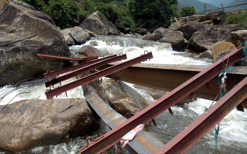 Hai thanh sắt dầm chính của cầu tạm chu va 6 có chiều dài mỗi thanh là 12m, nặng 8 tạ/thanh. Để đặt được hai thanh dầm này vào hai mấu cầu tạm, chính quyền địa phương phải huy động hơn 100 người khiêng…Tuy nhiên sáng sớm nay hai thanh dầm này đã bị lũ đẩy cong, ra xa so với vị trí ban đầu. (Ảnh: Nguyễn Công Hải/TTXVN)