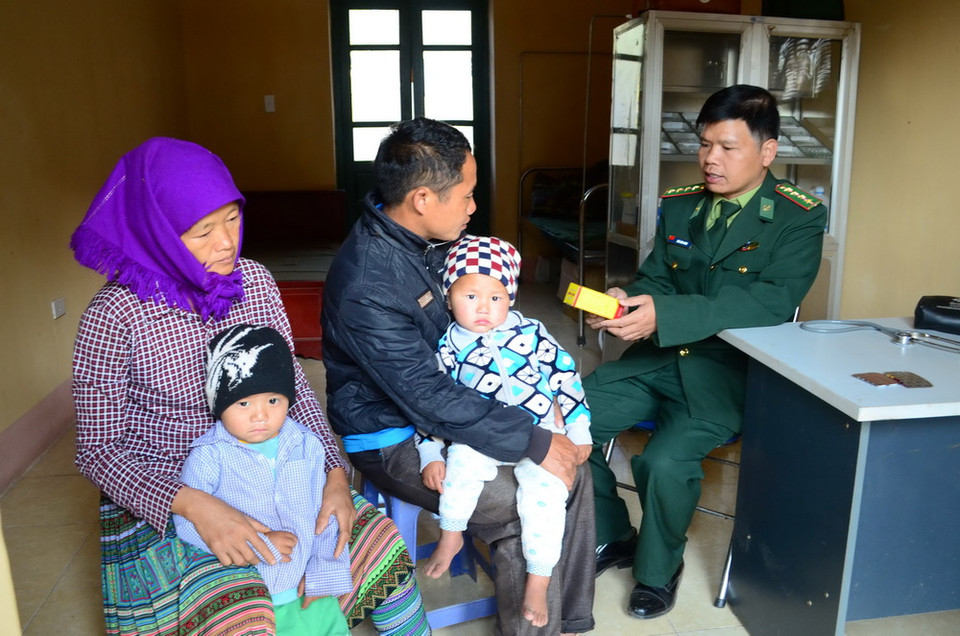 Chiến sỹ Đồn Biên phòng Nậm Nhừ (Điện Biên) phát thuốc cho người dân ở xã Nậm Nhừ. (Ảnh: Văn Dũng/TTXVN)
