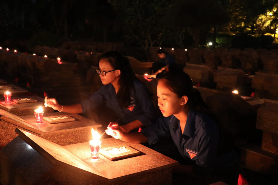 Thắp nến tri ân anh hùng liệt sỹ tại nghĩa trang tỉnh Bến Tre. (Ảnh: Huỳnh Phúc Hậu/TTXVN)