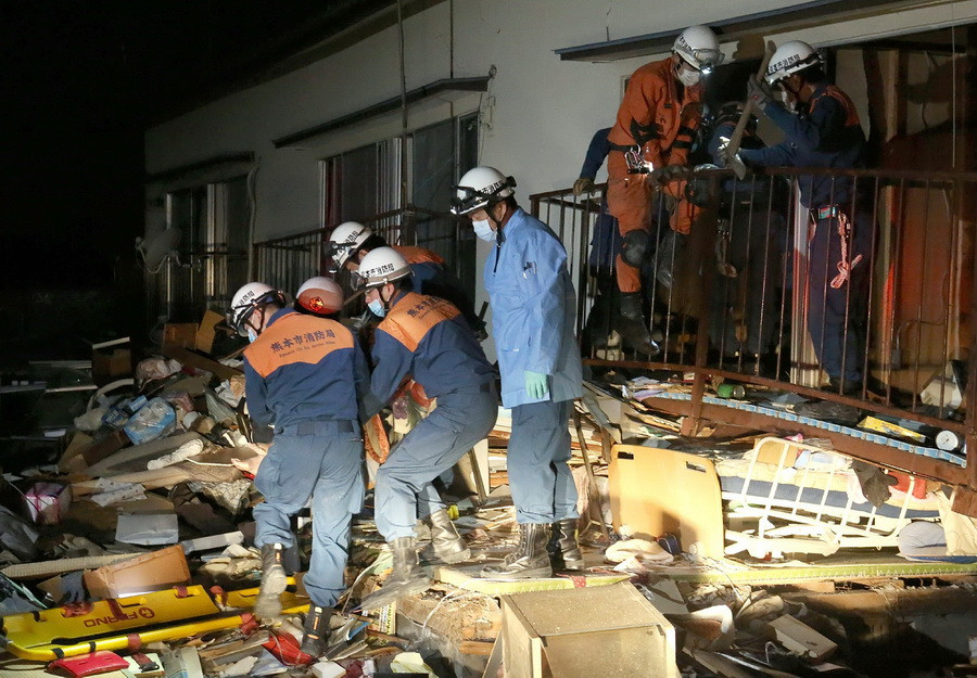 Lực lượng cứu hộ cứu một người dân khỏi căn nhà bị sập do động đất tại Kuammoto ngày 16/4. (Nguồn: AFP/TTXVN)