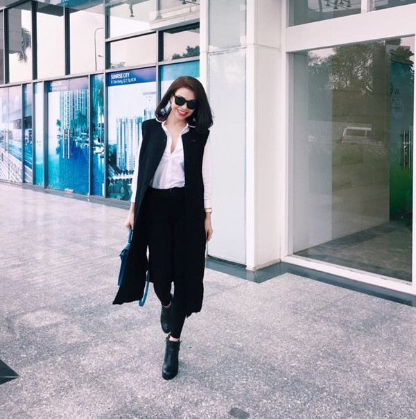 Trà Ngọc Hằng biến tấu quần jeans, áo sơmi đậm chất công sở bằng blazer dáng dài và đôi bốt da cá tính.