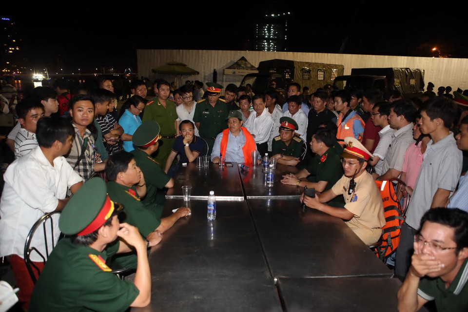 Lãnh đạo thành phố Đà Nẵng và các lực lượng chức năng bàn phương án tìm kiếm cứu người bị nạn tại hiện trường. (Ảnh: Trần Lê Lâm/TTXVN)