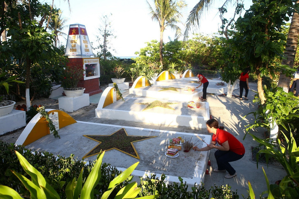 Đại biểu thắp hương mộ liệt sĩ trên đảo Nam Yết. (Ảnh: Minh Quyết/TTXVN)