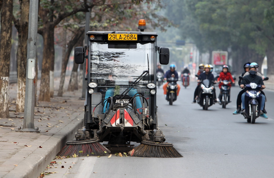 Công nhân Công ty Môi trường Đô thị miệt mài làm sạch đường phố cho nhân dân chào đón giao thừa. (Ảnh: Quốc Khánh/TTXVN)