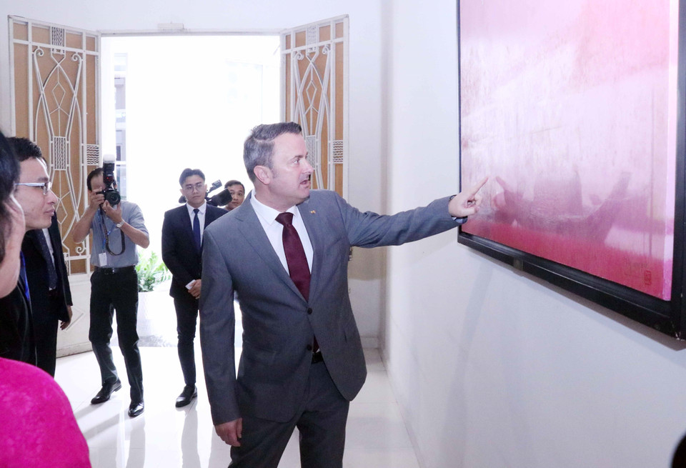 Ông Xavier Bettel - Thủ tướng Đại công quốc Luxembourg, thích thú với những bức tranh treo trong Sở Giao dịch Chứng khoán Thành phố Hồ Chí Minh. (Ảnh: Xuân Khu/TTXVN)