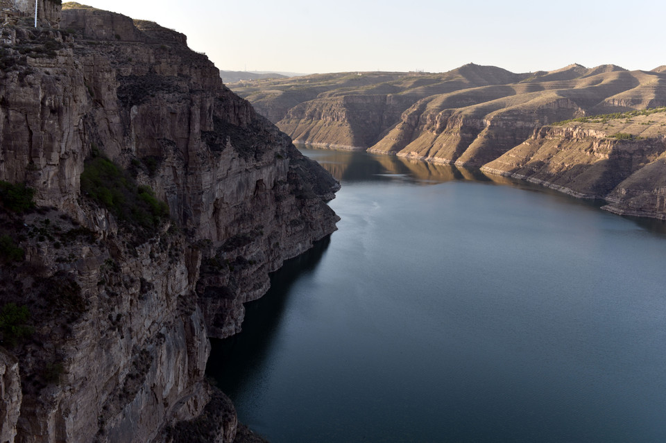 Những vách đá cao sừng sững với những hình thái kỳ thú, hùng vỹ soi bóng xuống dòng sông xanh thẳm và tĩnh lặng. (Ảnh: Vietnam+)