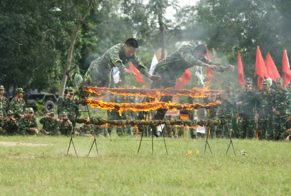 Các chiến sỹ thuộc lực lượng vũ trang Quảng Trị biểu diễn bay qua giàn lửa tại lễ ra quân huấn luyện. (Ảnh: Hồ Cầu/TTXVN)