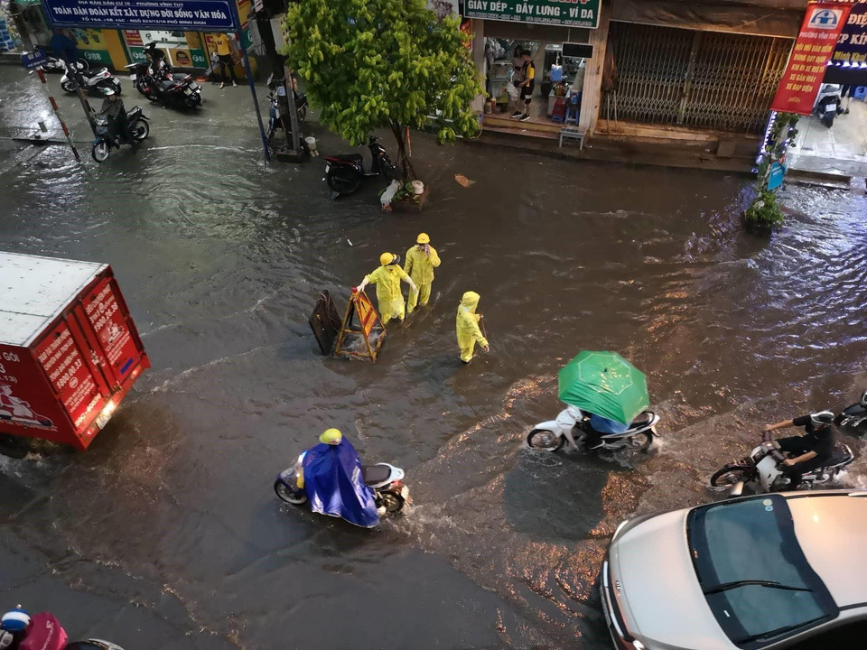 Cán bộ công ty thoát nước nhanh chóng có mặt tại các điểm úng ngập. (Ảnh: Thanh Tùng/TTXVN)