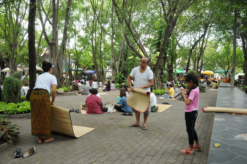 Phật tử thu dọn đồ đạc cá nhân sau khi chư Tăng ăn xong. (Ảnh: Sơn Nam-Quang Thuận/Vietnam+)