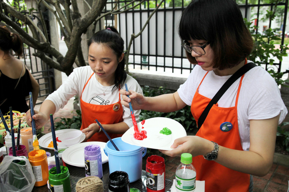 Các tình nguyện viên chuẩn bị đồ vẽ cho các bé. (Ảnh: Doãn Đức/Vietnam+)