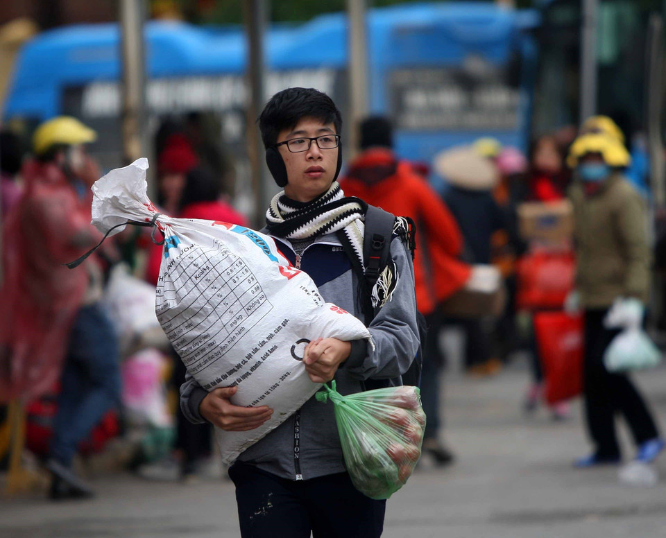 Người dân xuống xe khách với lỉnh kỉnh đồ đạc tại bến xe Giáp Bát. (Ảnh: Thanh Tùng/TTXVN)