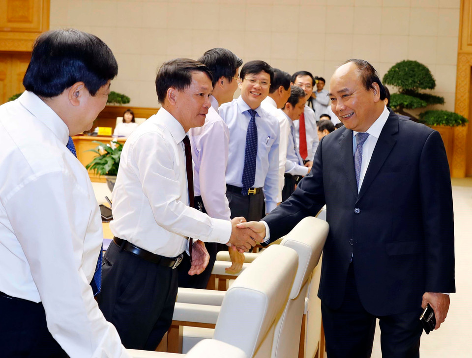 Thủ tướng Nguyễn Xuân Phúc và ông Nguyễn Đức Lợi, Ủy viên Trung ương Đảng, Tổng giám đốc TTXVN tại buổi làm việc. (Ảnh: Thống Nhất/TTXVN)