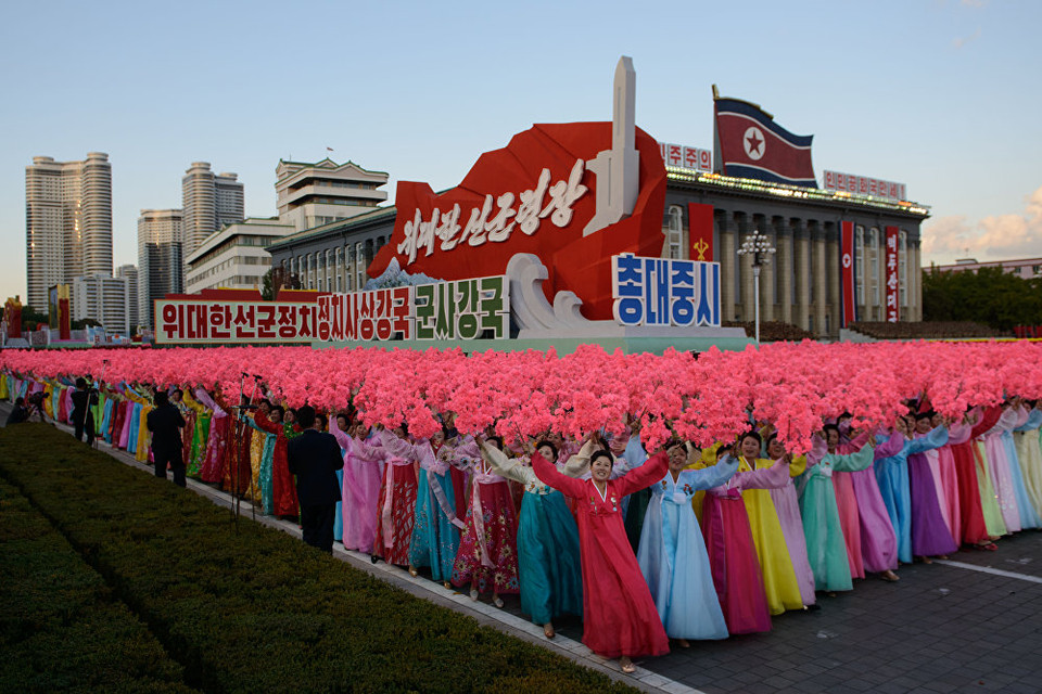Những người phụ nữ mặc trang phục hanbok truyền thống vẫy hoa khi đi qua quảng trường. (Nguồn: Sputniknews)