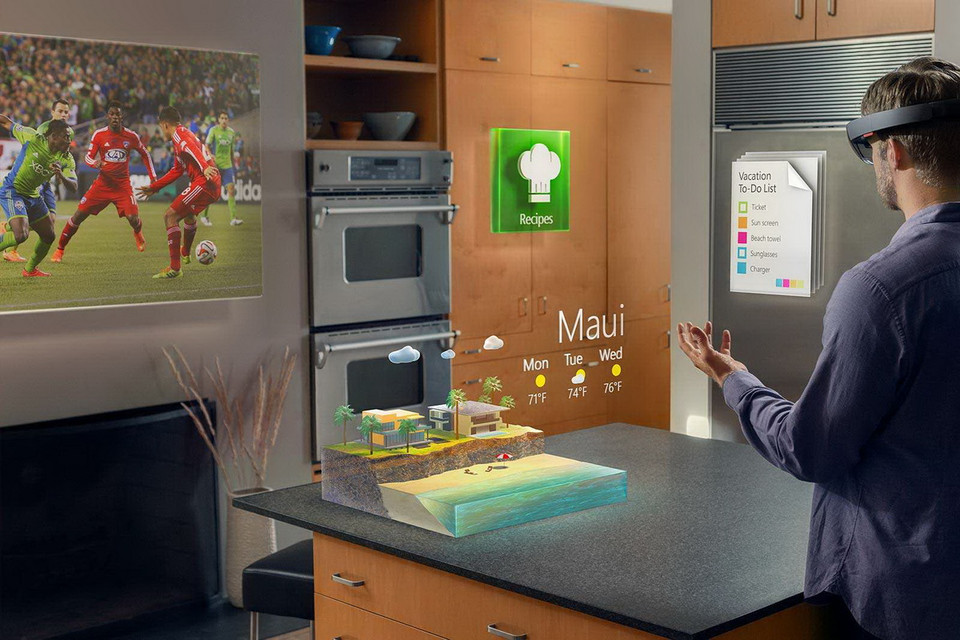 Microsoft HoloLens cho phép người dùng tương tác với những hình ảnh ba chiều pha trộn với những hình ảnh của thế giới thực. Người dùng có thể vừa giải trí, vừa làm việc... (Nguồn: Microsoft) 
