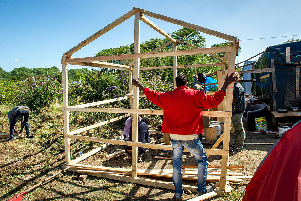 Những người di cư từ Sudan xây dựng một nhà tạm trú ở trong rừng. (Nguồn: AFP)