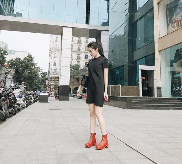 Huyền My cũng ứng dụng phong cách tối giản vào set đồ xuống phố ngày mát mẻ. Á hậu diện đầm đen dáng suông và mang túi tiệp màu, nhấn nhá bằng đôi bốt da màu sắc tươi sáng.