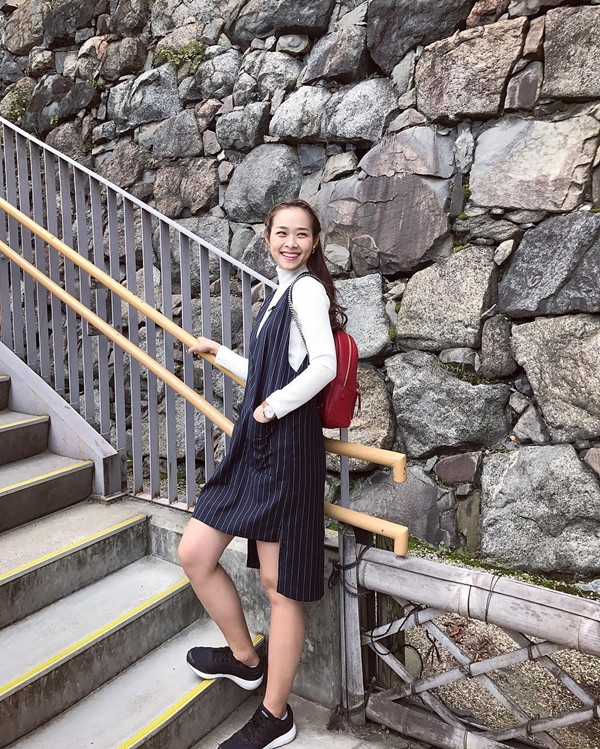 Kiều nữ 9X còn thể hiện gu thời trang sáng tạo bằng mix layer áo thun dài tay và đầm kẻ sọc màu đen có thiết kế bất đối xứng. Diệp Bảo Ngọc cũng tô đậm vẻ trẻ trung khi kết hợp ba lô da màu đỏ làm phụ kiện chấm phá.