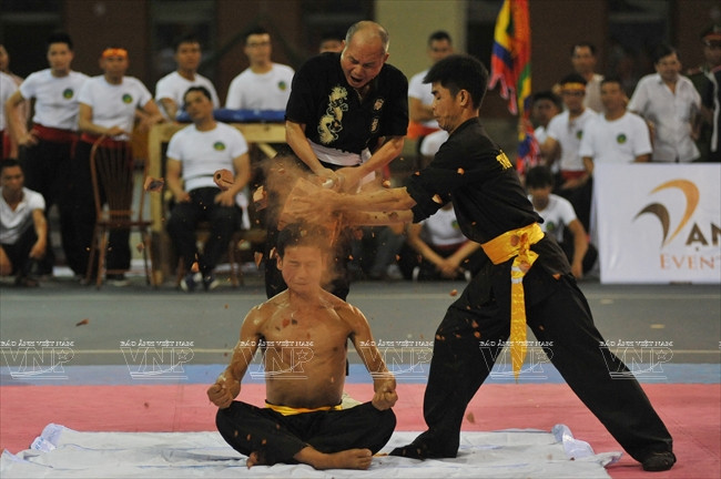 Dùng búa tạ đập vỡ chồng gạch đặt trên đầu một võ sinh. (Ảnh: Trần Thanh Giang/Báo ảnh Việt Nam)