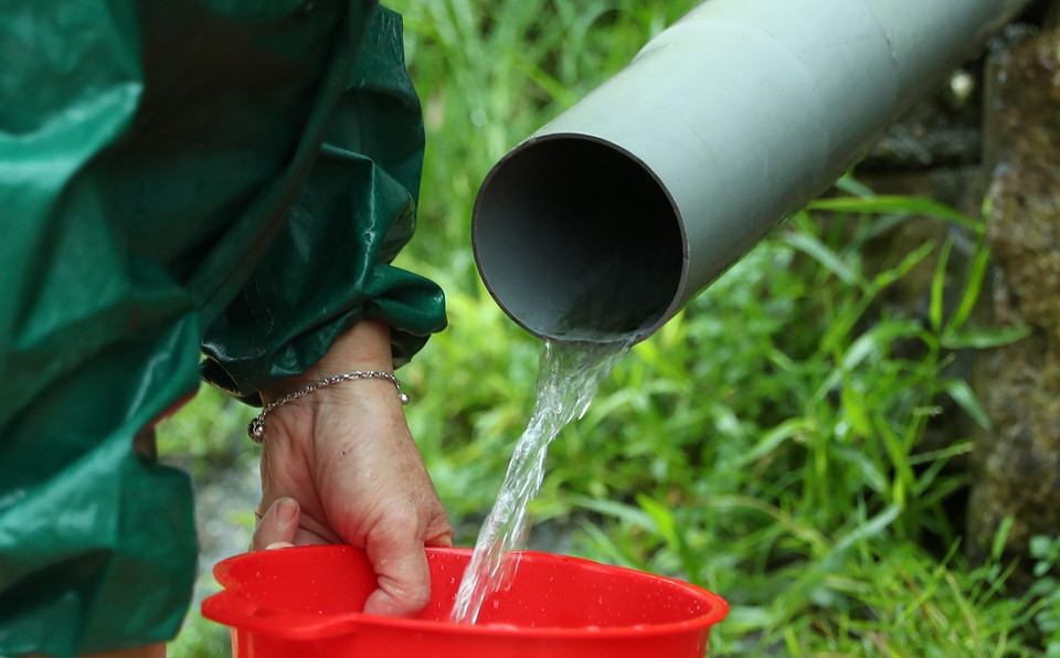 Do ảnh hưởng của bão số 3, ngày 9/9, mưa to và nước lũ tiếp tục dâng cao ở sông, suối tại nhiều nơi, gây ngập lụt, hư hỏng trạm bơm, ống dẫn nước thô của nhà máy nước trên địa bàn tỉnh Lào Cai, nên không thể cấp nước sinh hoạt đến người dân như mọi ngày. Người dân phải nhọc nhằn hứng từng dòng nước được chảy ra từ khe núi đem về sử dụng sinh hoạt gia đình. (Ảnh: Quốc Khánh/TTXVN)