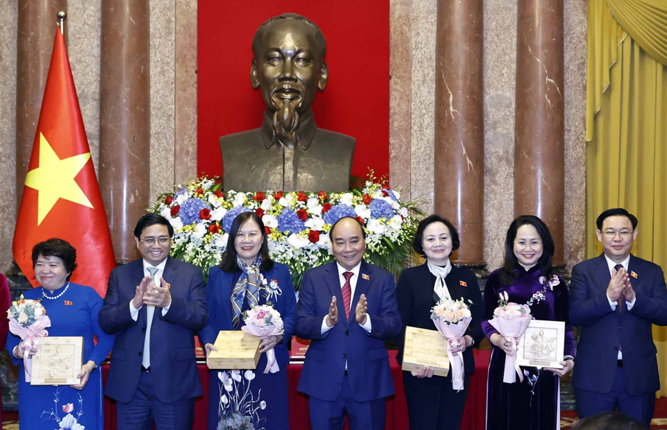 Chủ tịch nước Nguyễn Xuân Phúc, Thủ tướng Chính phủ Phạm Minh Chính, Chủ tịch Quốc hội Vương Đình Huệ tặng hoa cho các nữ đại biểu. (Ảnh: Thống Nhất/TTXVN)